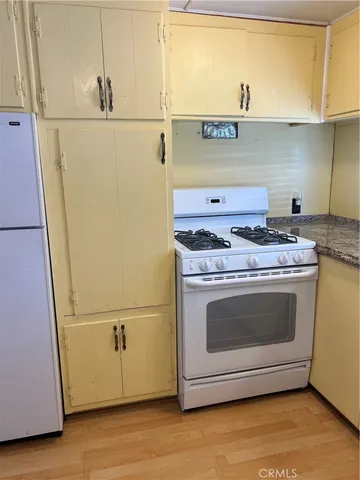 a stove top oven sitting inside of a kitchen