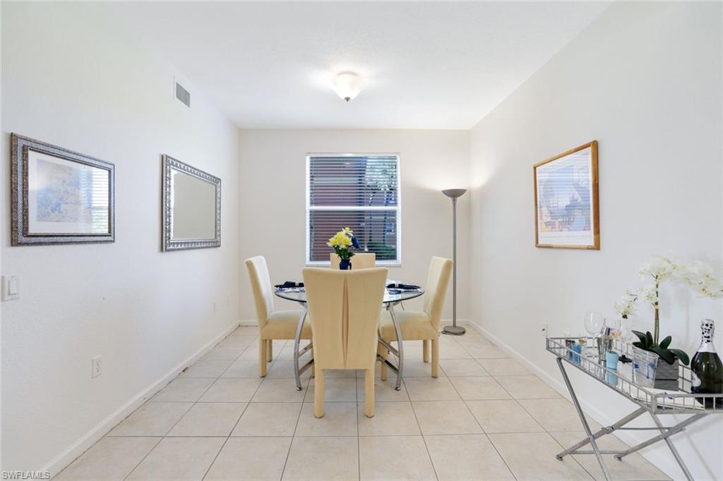 10049 Heather Lane, Unit 101 Naples, FL 34119 - Photo 17 of 28 Dining space featuring light tile patterned flooring and baseboards