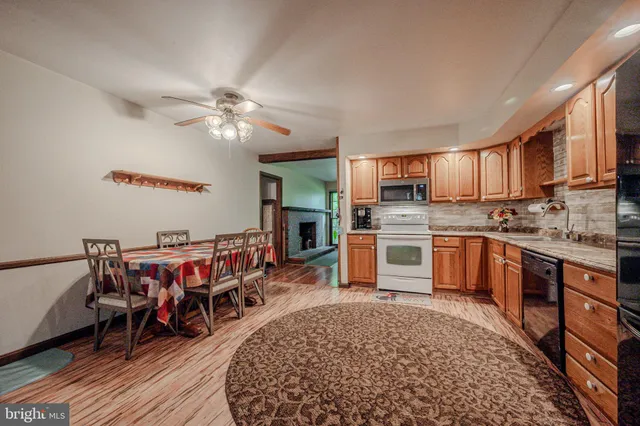 a view of a dining room with furniture and chandelier
