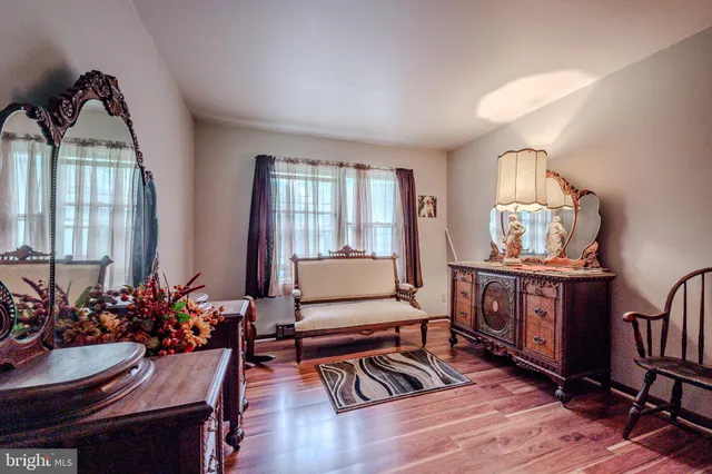a living room with furniture a wooden floor and a window