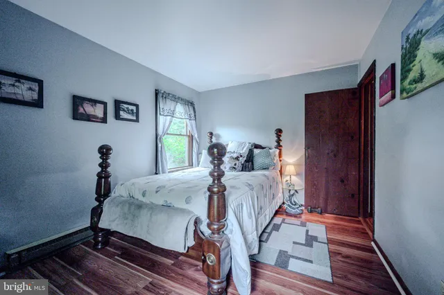 a bedroom with bed and a dresser