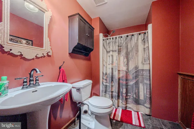 a living room with furniture and wooden floors
