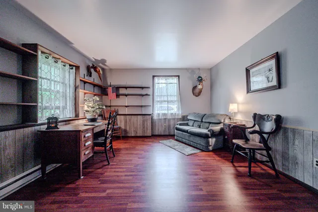 a view of a livingroom with furniture and a hardwood floor
