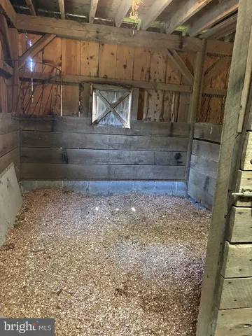 a view of room with furniture and a kitchen