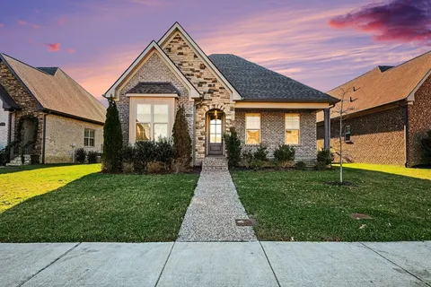 a front view of a house with garden