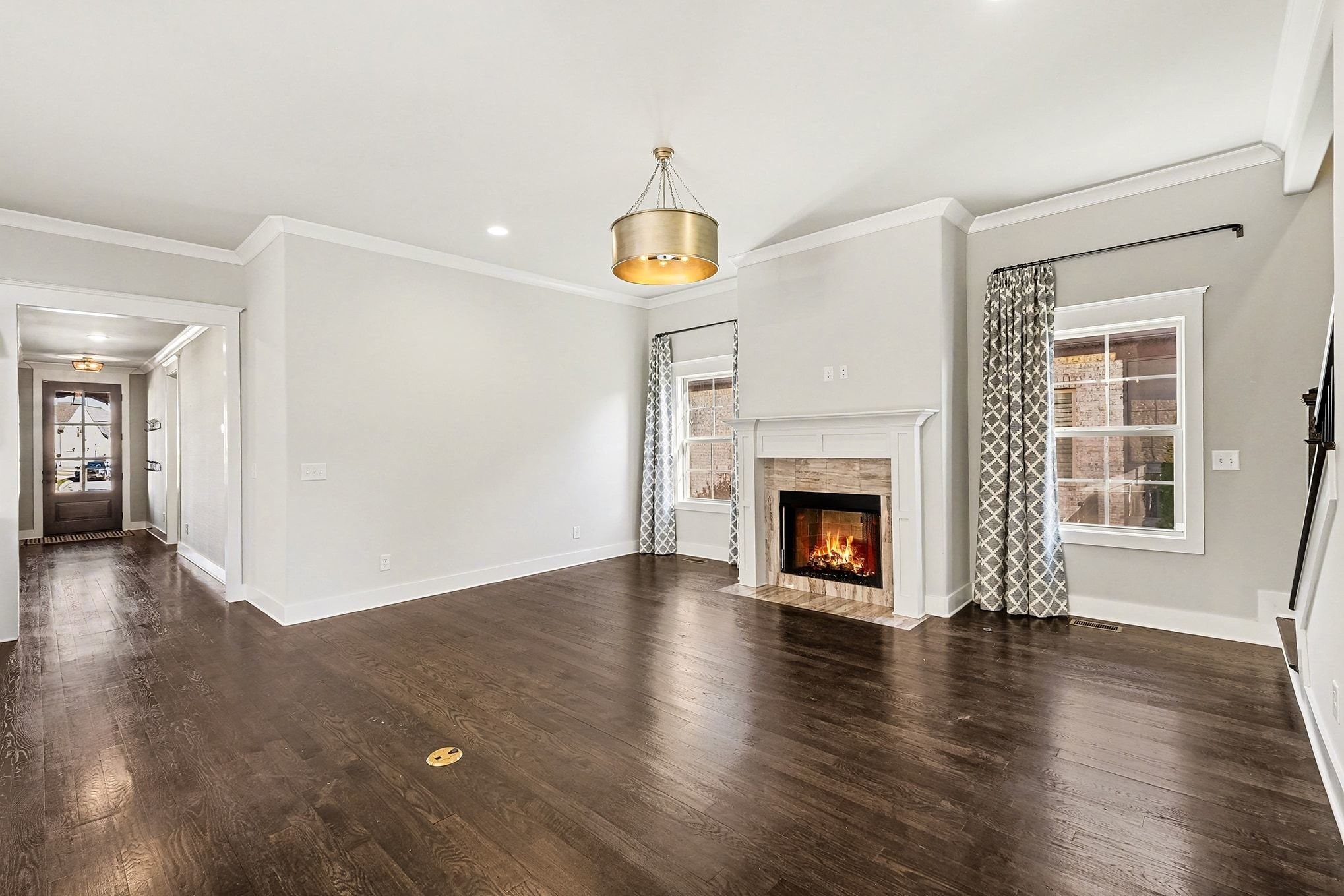 3008 Turnstone Trace Spring Hill, TN 37174 - Photo 5 of 30 a view of an empty room with wooden floor fireplace and a window