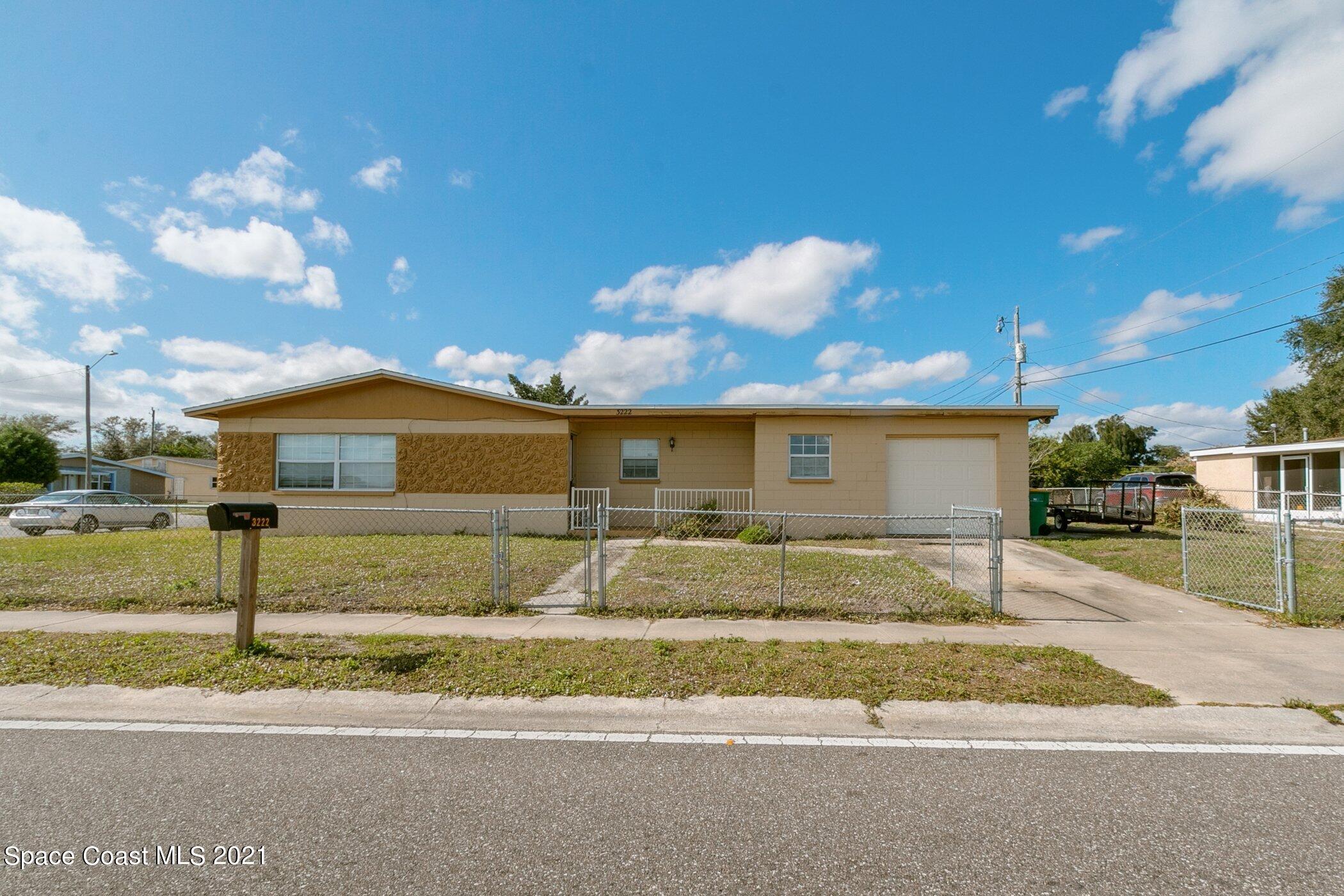 3222 Lipscomb Street Melbourne, FL 32901 - Photo 1 of 27 a front view of a house with a yard