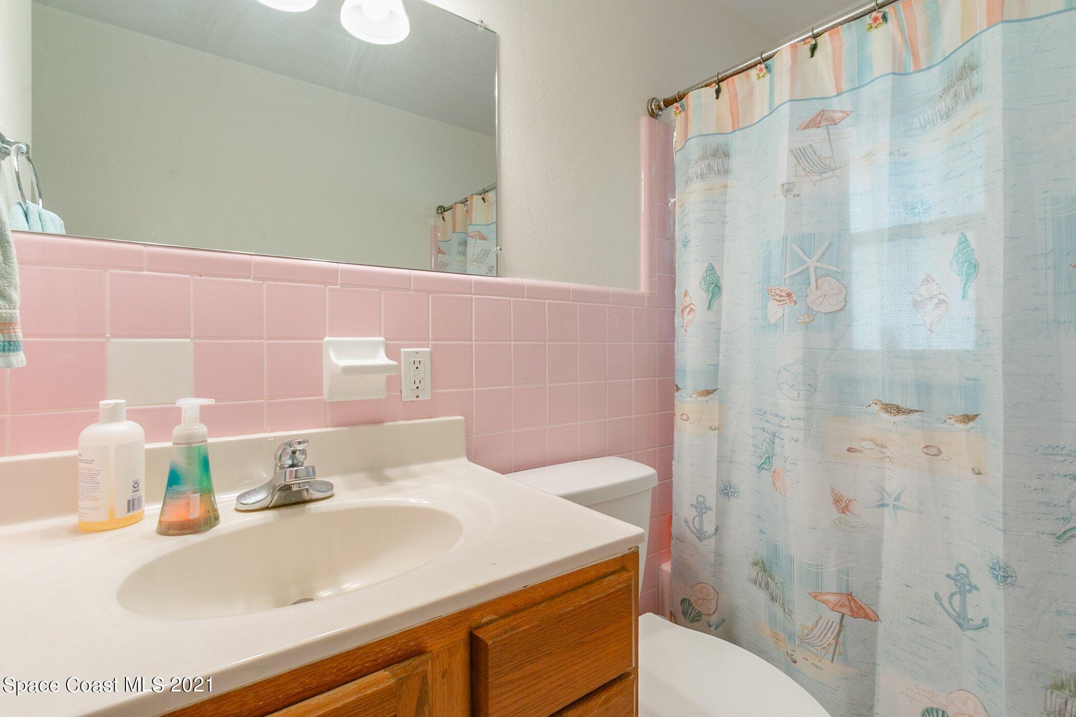 3222 Lipscomb Street Melbourne, FL 32901 - Photo 24 of 27 a bathroom with a sink and a mirror