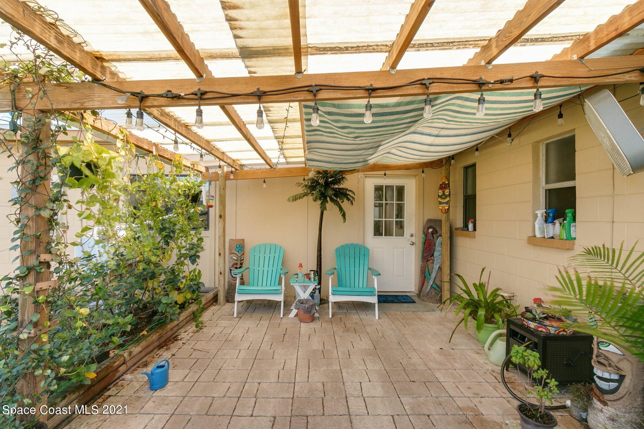 3222 Lipscomb Street Melbourne, FL 32901 - Photo 27 of 27 a view of a porch with furniture and a potted plant