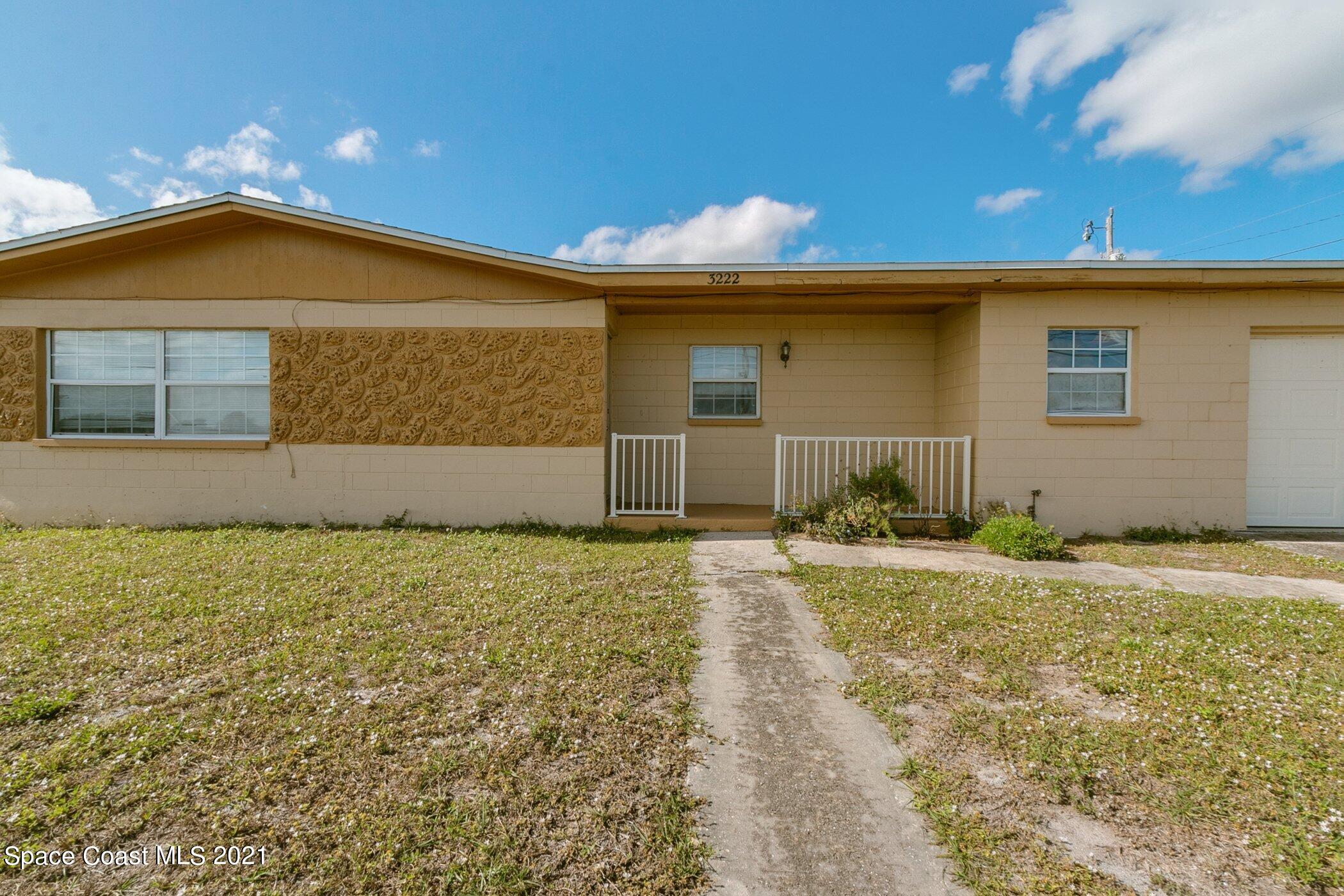 3222 Lipscomb Street Melbourne, FL 32901 - Photo 3 of 27 a front view of a house with a yard