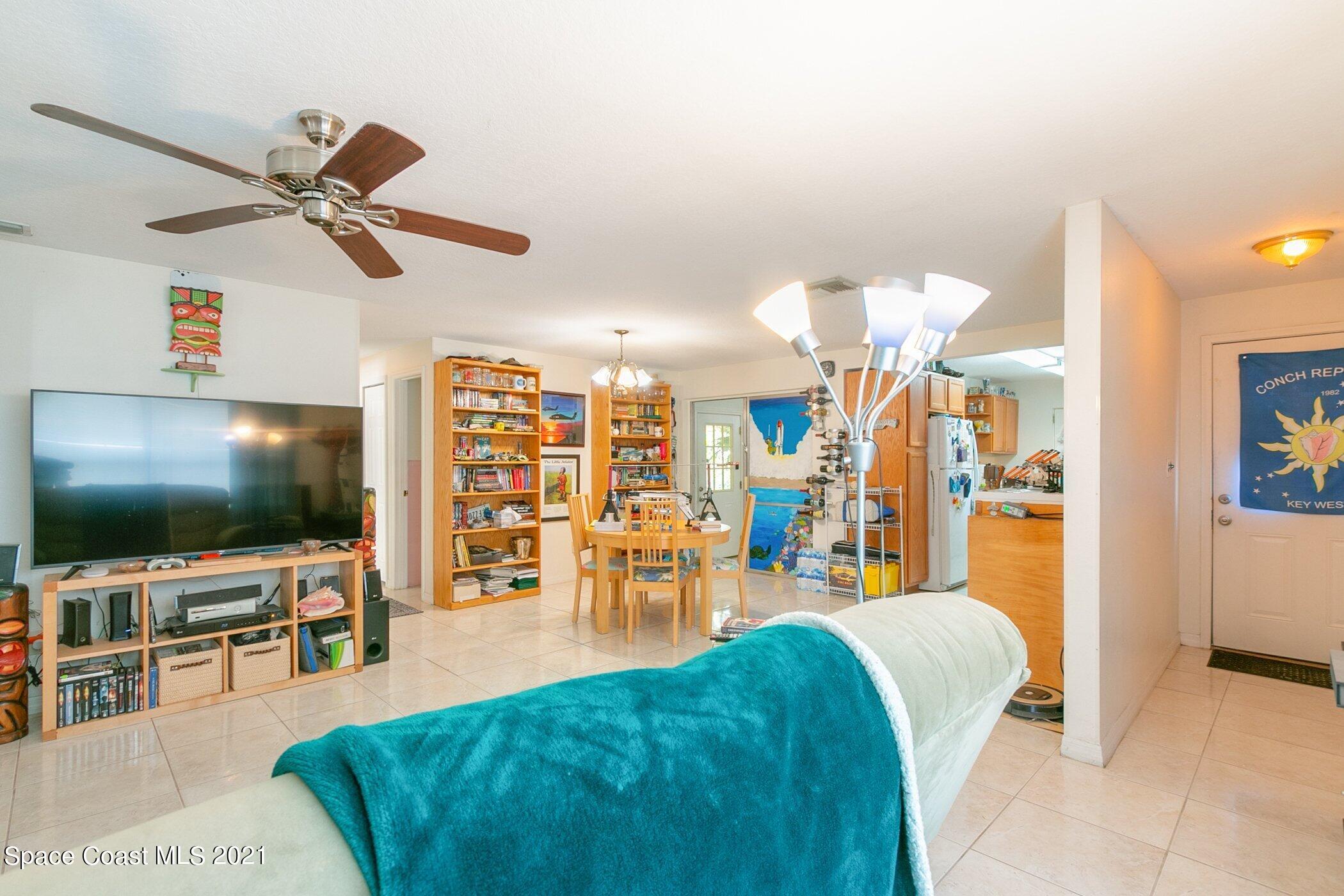 3222 Lipscomb Street Melbourne, FL 32901 - Photo 5 of 27 a living room with lots of furniture and a flat screen tv
