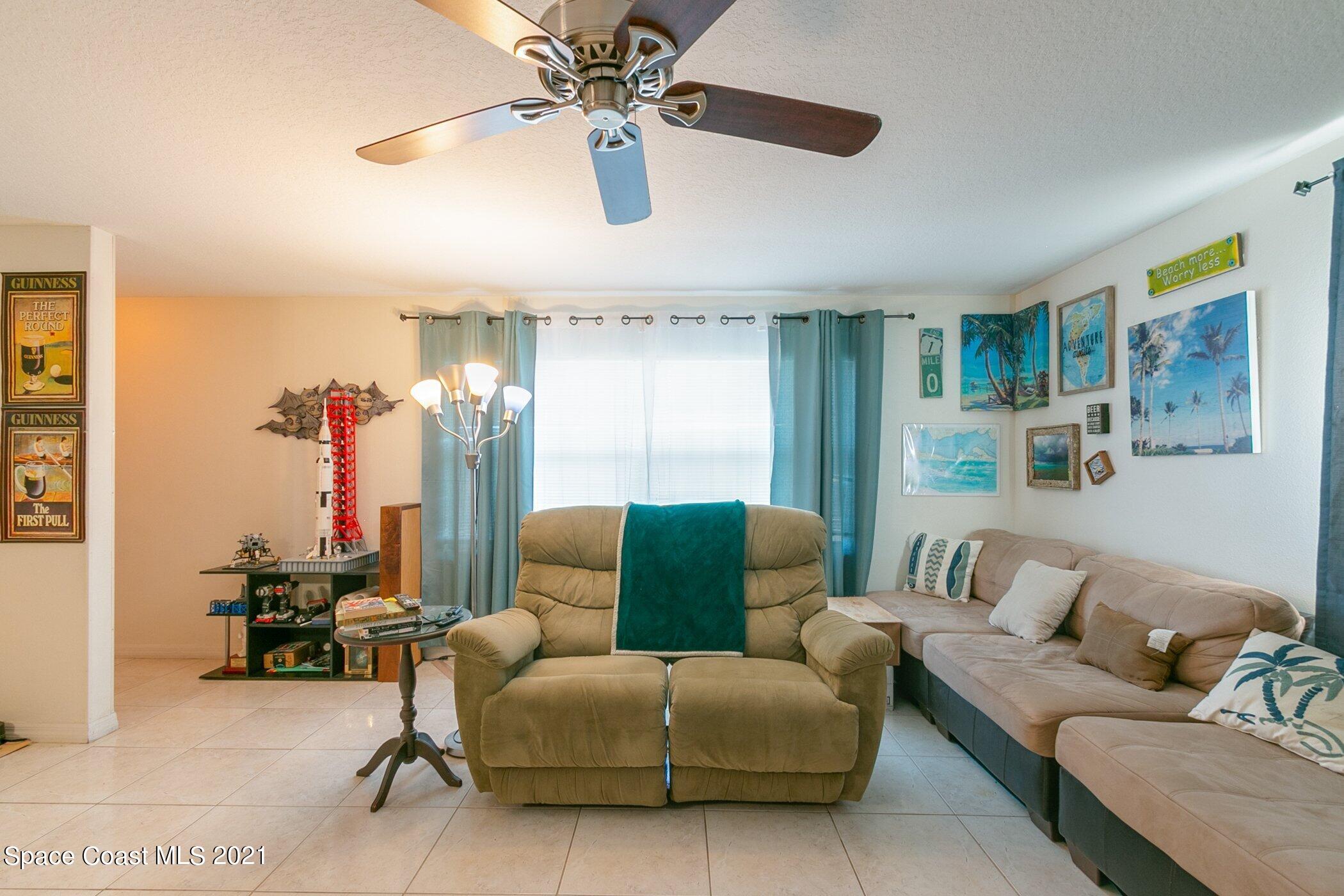 3222 Lipscomb Street Melbourne, FL 32901 - Photo 6 of 27 a living room with furniture and a chandelier