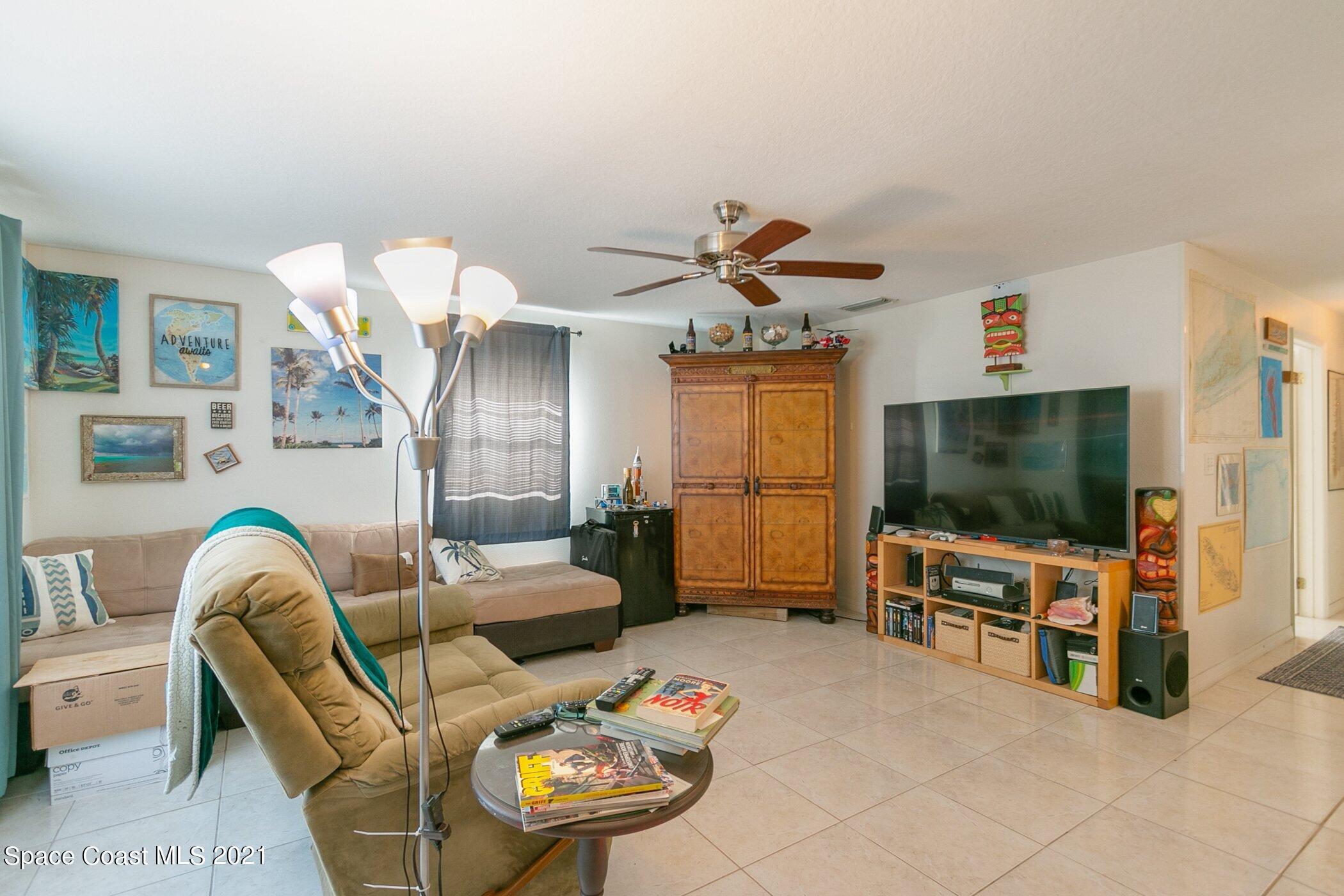 3222 Lipscomb Street Melbourne, FL 32901 - Photo 7 of 27 a living room with furniture and a flat screen tv