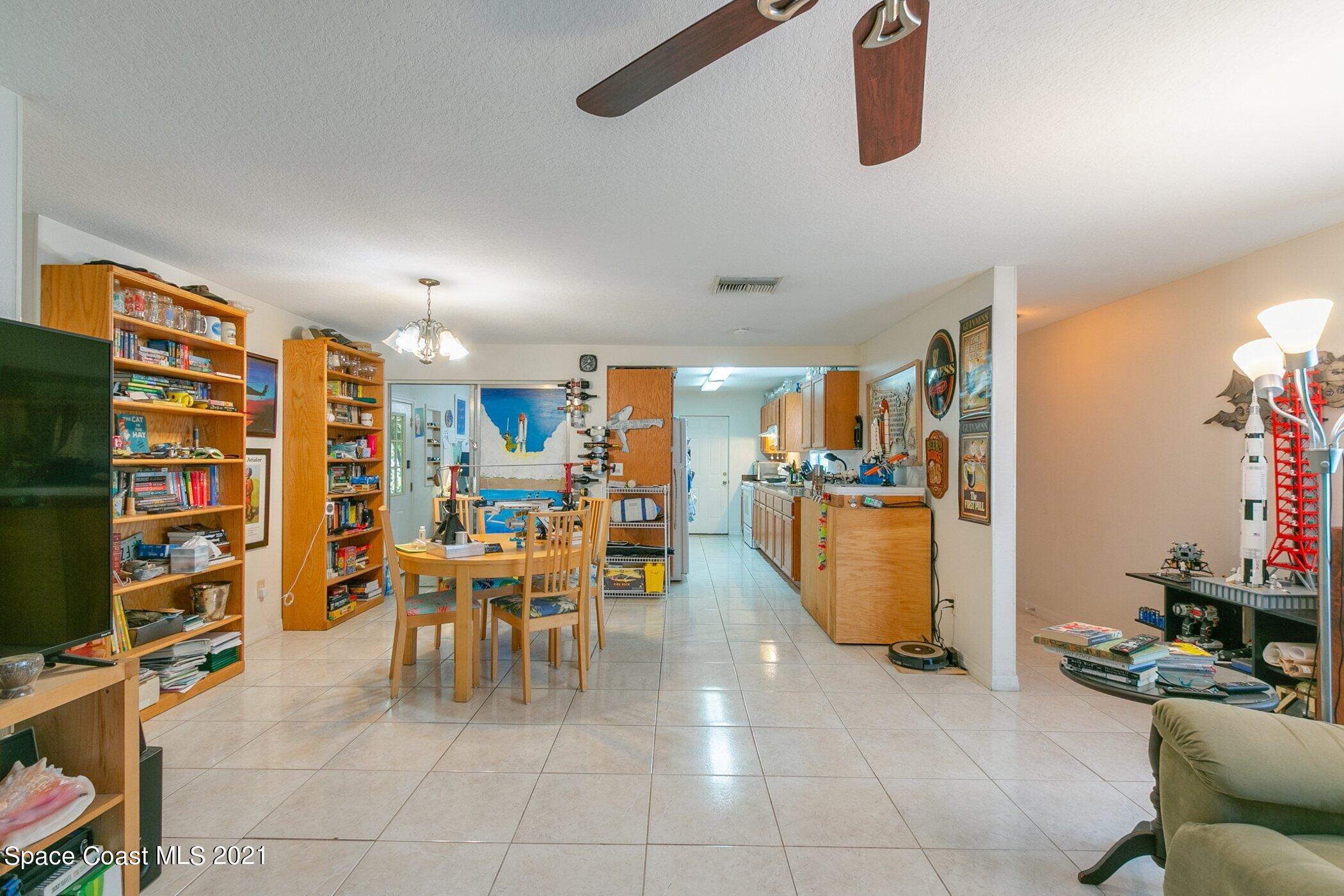 3222 Lipscomb Street Melbourne, FL 32901 - Photo 8 of 27 a dining room with furniture and a book shelf