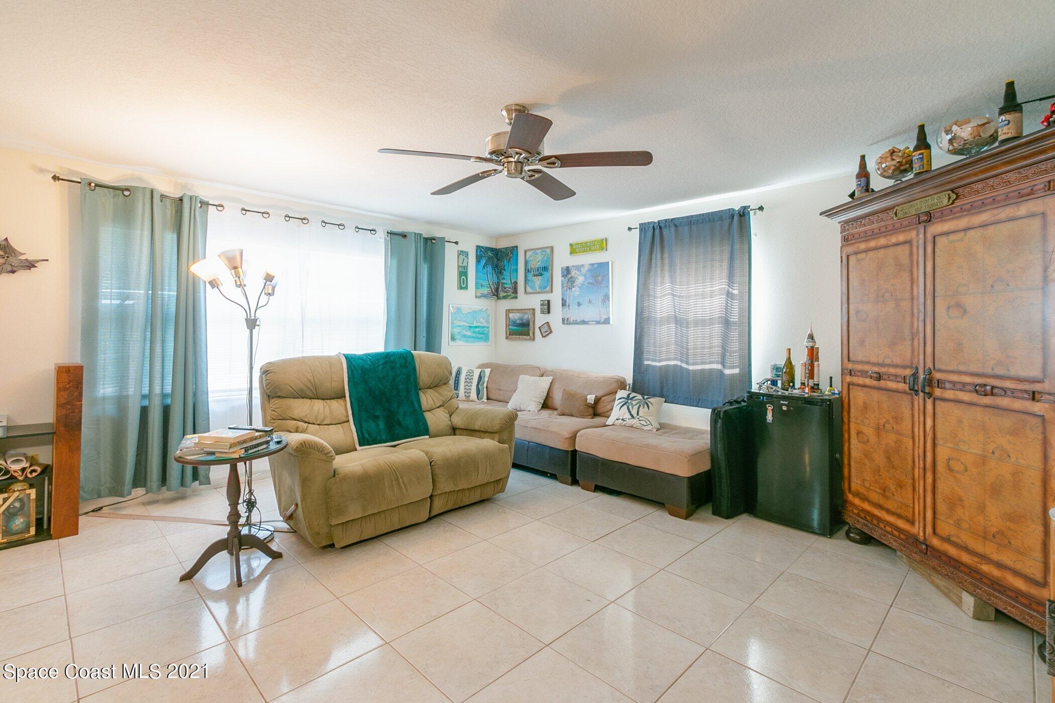 3222 Lipscomb Street Melbourne, FL 32901 - Photo 9 of 27 a living room with furniture and a chandelier