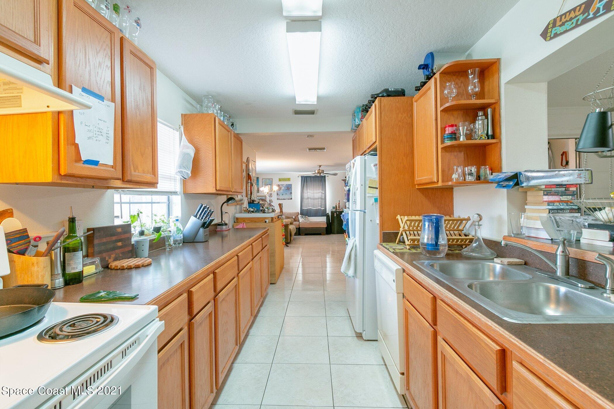 3222 Lipscomb Street Melbourne, FL 32901 - Photo 10 of 27 a kitchen with stainless steel appliances granite countertop a sink and cabinets