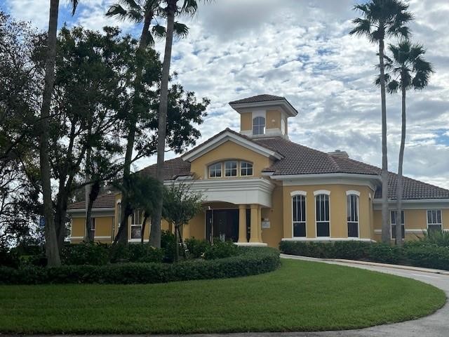 5060 Fairways Circle, Unit F207 Vero Beach, FL 32967 - Photo 1 of 14 a front view of a house with a garden