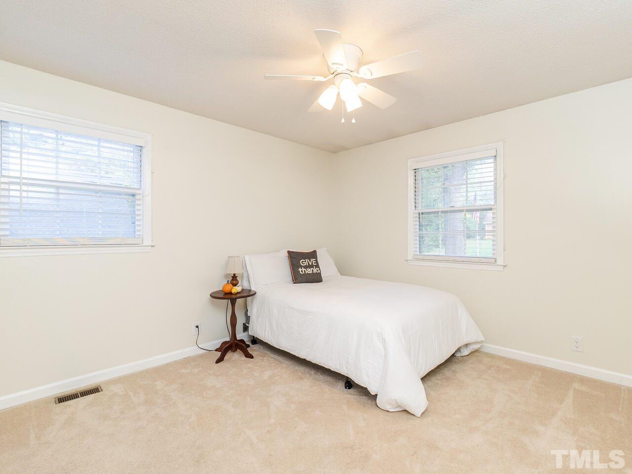 4313 Hopson Drive Raleigh, NC 27604 - Photo 17 of 30 a bedroom with a bed and window