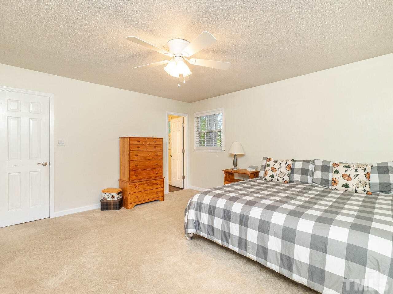 4313 Hopson Drive Raleigh, NC 27604 - Photo 20 of 30 a bedroom with a bed and a chandelier
