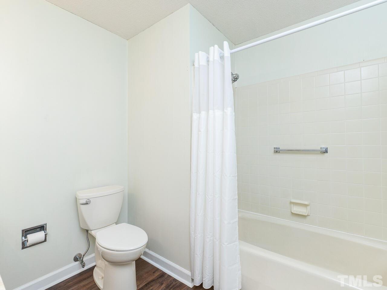 4313 Hopson Drive Raleigh, NC 27604 - Photo 22 of 30 a bathroom with a toilet and a bathtub