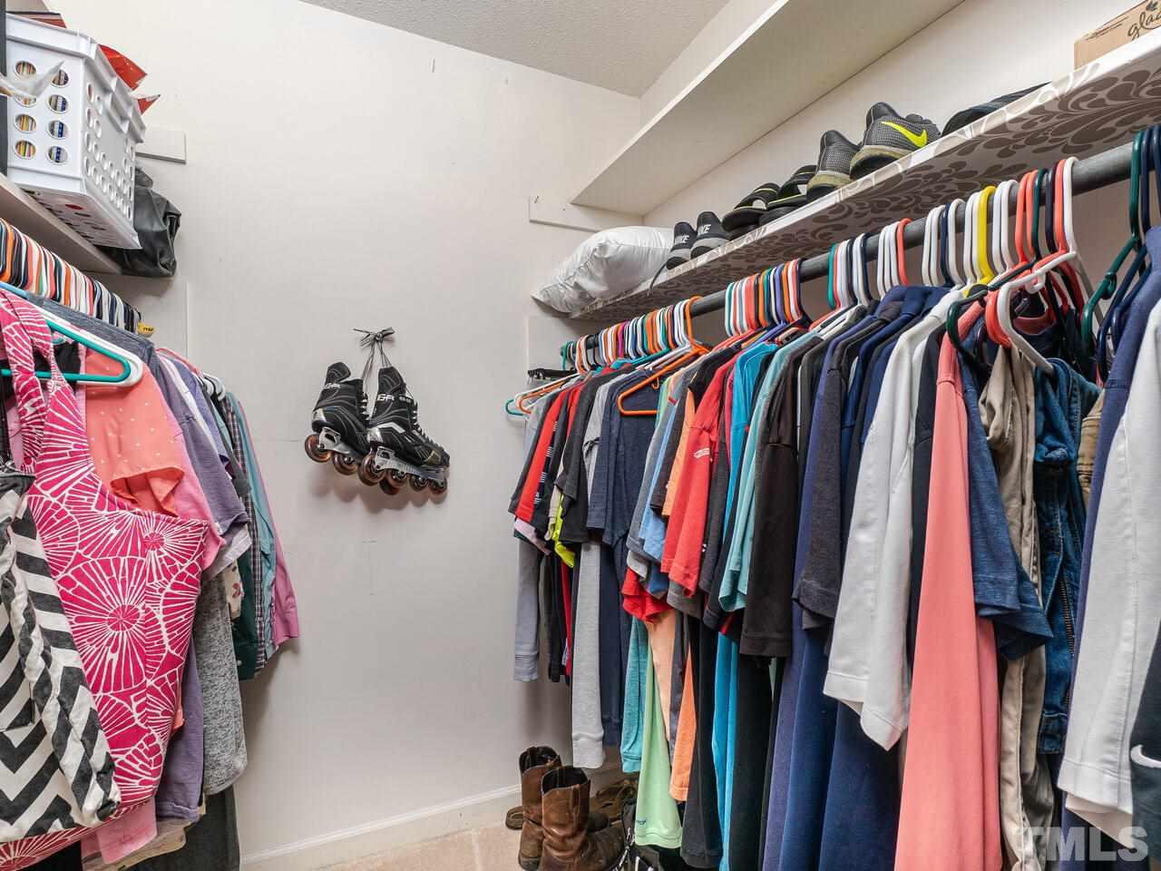 4313 Hopson Drive Raleigh, NC 27604 - Photo 23 of 30 a view of walk in closet with clothes and shoes
