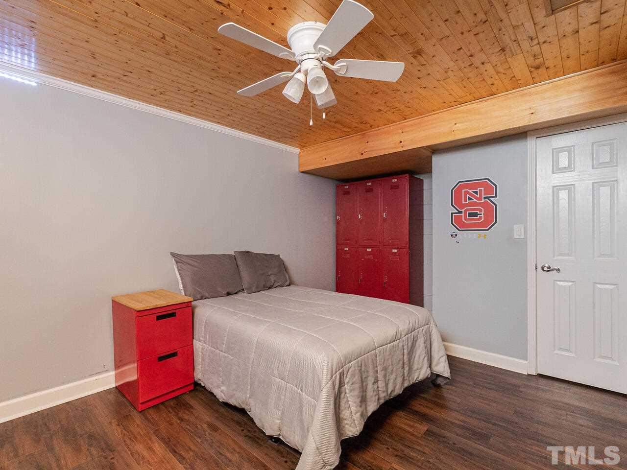 4313 Hopson Drive Raleigh, NC 27604 - Photo 24 of 30 a bedroom with bed and wooden floor