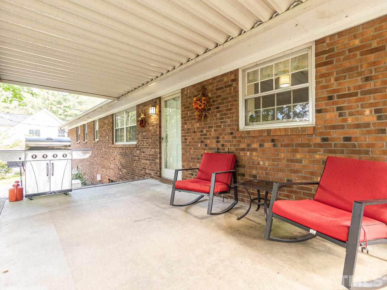 4313 Hopson Drive Raleigh, NC 27604 - Photo 28 of 30 a view of a patio with a table and chairs