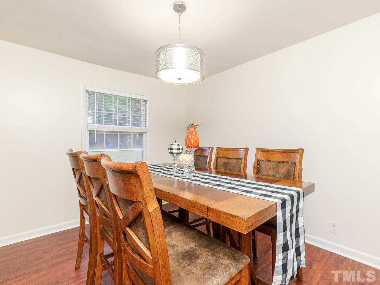 4313 Hopson Drive Raleigh, NC 27604 - Photo 6 of 30 a view of a dining room with furniture and wooden floor