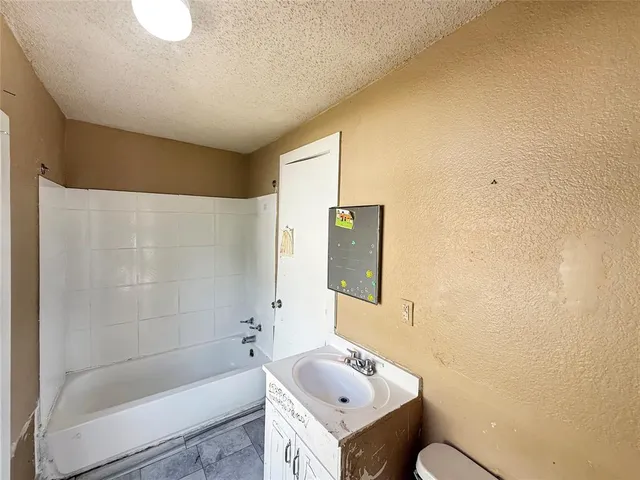 a bathroom with a sink a toilet and bathtub