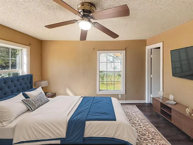 a bedroom with a large bed and a window