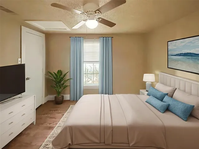 a bedroom with a bed and a flat screen tv