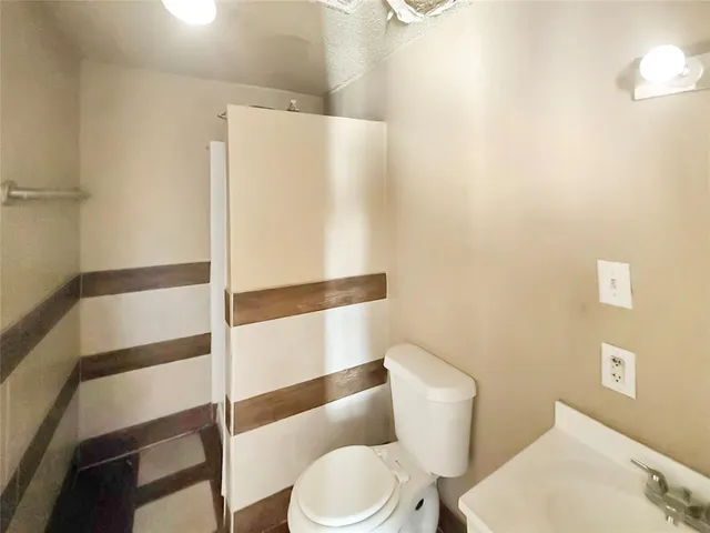 a white toilet sitting next to a bathroom sink