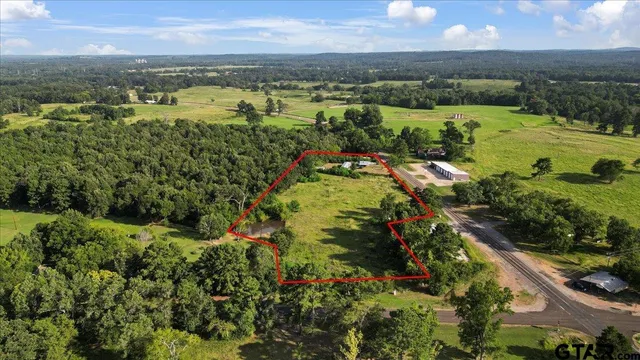 an aerial view of residential houses with outdoor space and river