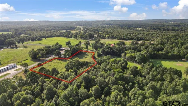 an aerial view of a houses with a lake view