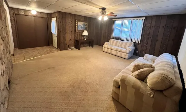 a bedroom with furniture and a large window