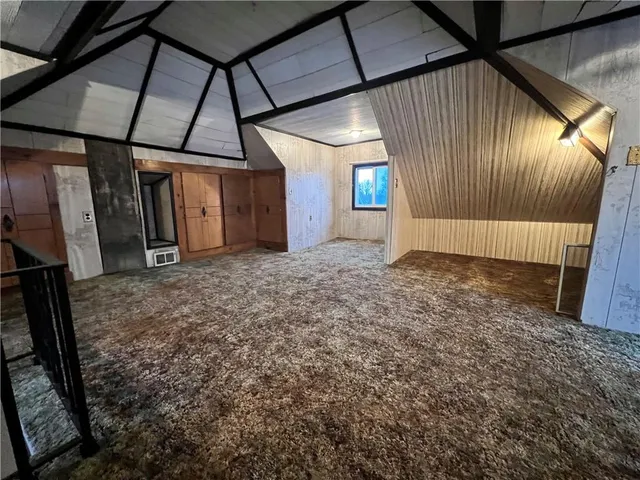 a view of a livingroom with furniture wooden floor and front door