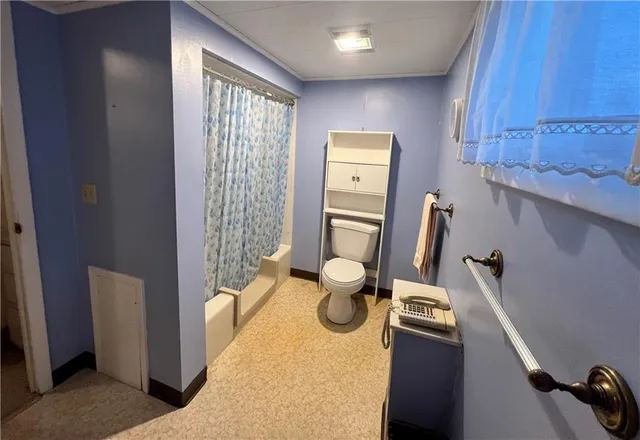 a kitchen with stainless steel appliances a sink dishwasher a refrigerator and wooden cabinets