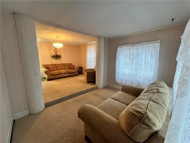 a living room with furniture and a glass door