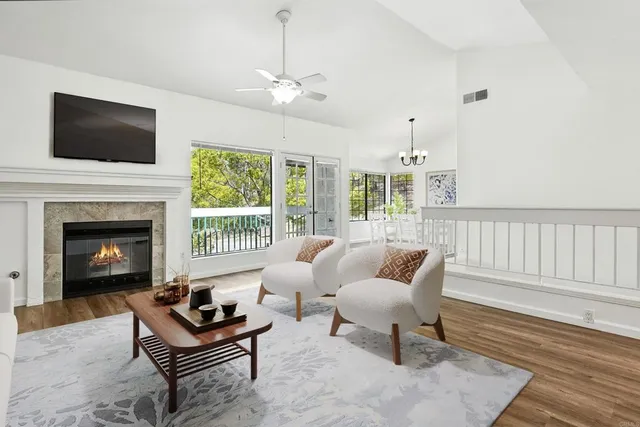 a living room with furniture fireplace and flat screen tv