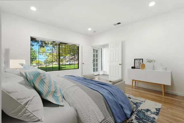 a spacious bedroom with a bed and a window