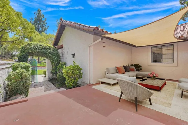 a backyard of a house with table and chairs