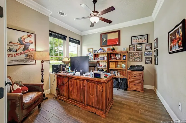 a view of a workspace with furniture and a window