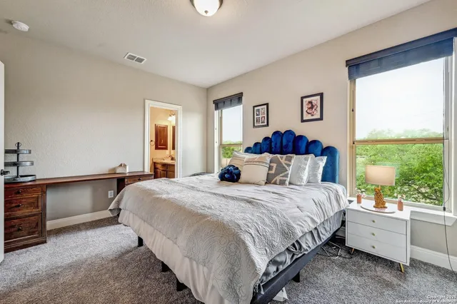 a bedroom with a bed and a large window