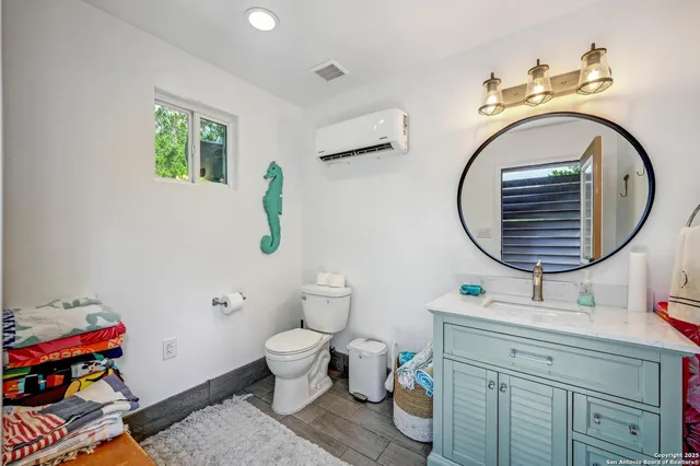 a bathroom with a toilet a sink and a mirror