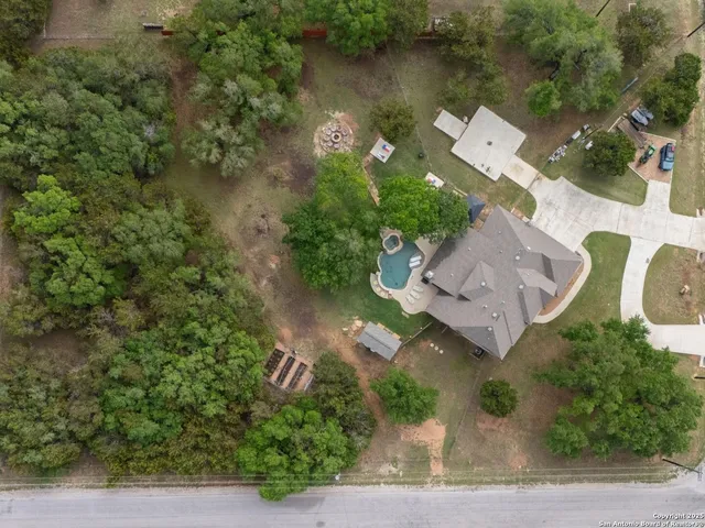 an aerial view of a house with outdoor space and lake view
