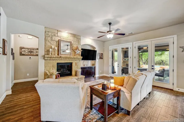 a living room with furniture a fireplace and a flat screen tv