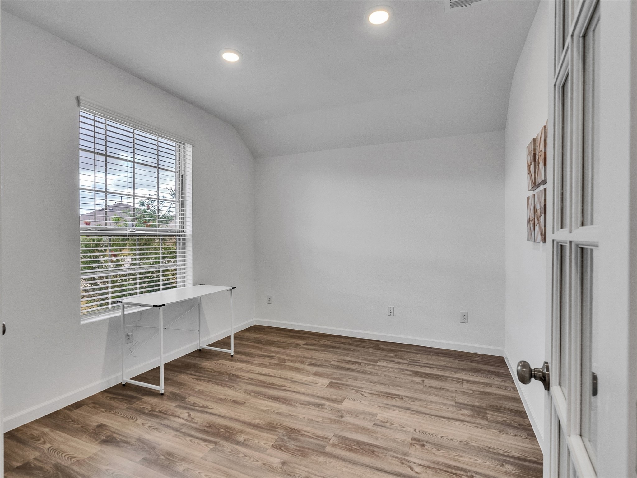 3712 Windy Brk Road Rosenberg, TX 77469 - Photo 5 of 36 a view of an empty room with wooden floor and a window