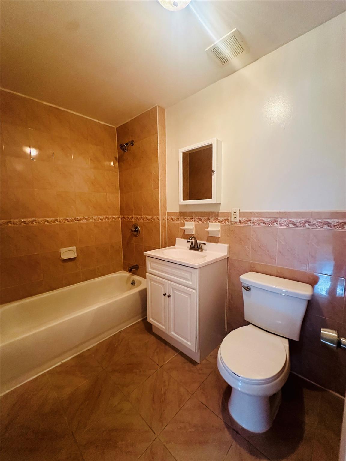 1079 Willoughby Avenue Brooklyn, NY 11221 - Photo 15 of 19 a bathroom with a toilet a sink a bath tub and mirror