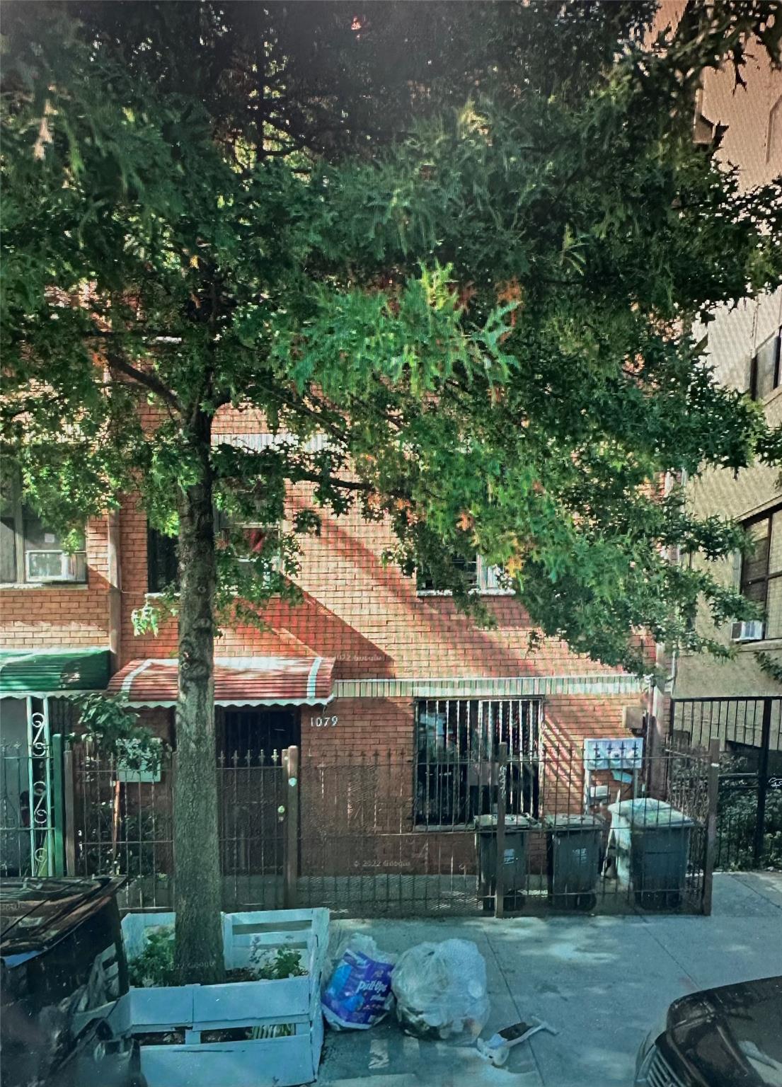 1079 Willoughby Avenue Brooklyn, NY 11221 - Photo 19 of 19 a front view of a house with a garden