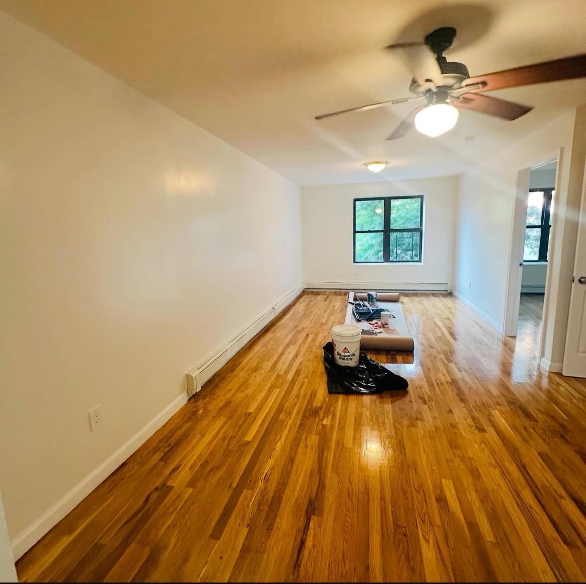 1079 Willoughby Avenue Brooklyn, NY 11221 - Photo 2 of 19 a bed room with a bed and wooden floor